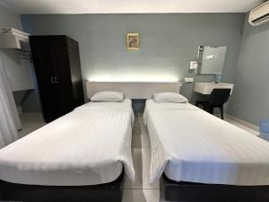 Postel nebo postele na pokoji v ubytování De UPTOWN Hotel @ P.J. 222