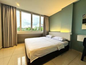 a bedroom with a bed and a large window at De UPTOWN Hotel @ P.J. 222 in Petaling Jaya