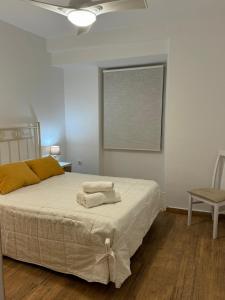 a bedroom with a bed with two towels on it at Apartamento Irene 2 in Caravaca de la Cruz