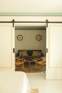 a living room with a couch and a table at Hotel des Dunes in Cap-Ferret
