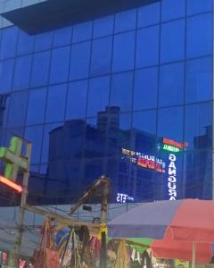 a reflection of a city in the windows of a building at Jupiter Beach Resort , Puri in Puri