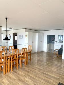 a dining room and living room with a table and chairs at Äleklinta Gård in Äleklinta