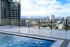 a swimming pool on the roof of a building at Quezon City Apartment1 Condo Victoria Sports Tower in Manila