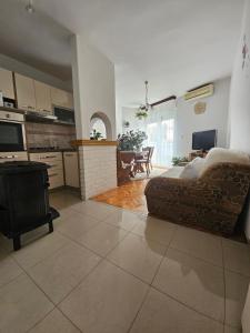 a living room with a couch and a kitchen at Apartman Noa in Knin
