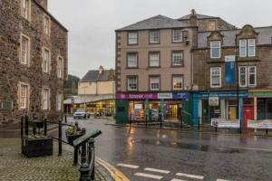 a city street in the rain with buildings at Towerknowe in Hawick