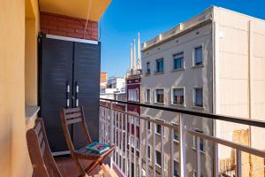 a chair on the balcony of a building at 5 min to the sea and 15 min to Barcelona center in Sant Adria de Besos