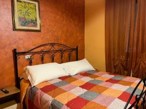 a bedroom with a bed with a colorful quilt at Le Ganze in Ceprano
