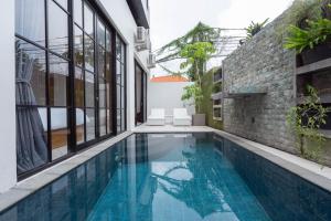 a swimming pool in the middle of a building at The Lavana Seminyak Loft 360 - 1 Bedroom Villa with Private Pool in Seminyak