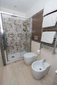 a bathroom with a shower and a toilet and a sink at Il Paradiso sul Mare Apartment in Scala