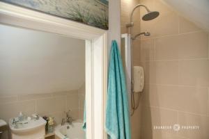 a bathroom with a shower and a sink and a mirror at Lovely 1bed Suite close to Beach and with Parking - Sky View Suite in Bournemouth