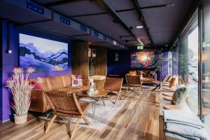 a lobby with couches and tables and chairs at Capsule Hotel - Chapter Lucerne in Luzern