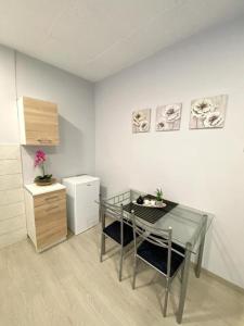 a dining room with a table and a refrigerator at Dima Rooms And Apartments in Athens