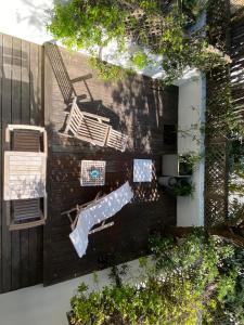 an overhead view of a garden with a bench and a chair at Hotel des Dunes in Cap-Ferret