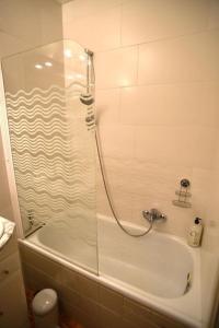 a bathroom with a shower and a bath tub at Leuven Centrum Comfort in Leuven