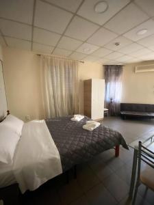 Posteľ alebo postele v izbe v ubytovaní Dima Rooms And Apartments