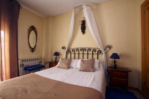 a bedroom with a bed with a canopy at Hotel Arco San Vicente in Ávila +27 photos
