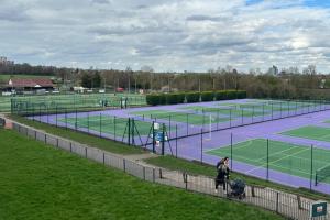 two tennis courts with people standing on them at Wimbledon 2 Bed Tennis & Travel in London