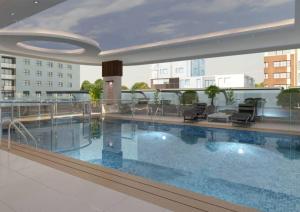 a large swimming pool on top of a building at Stella Stays Stunning 1 BDR Dubai Tecom Netflix Pool in Dubai