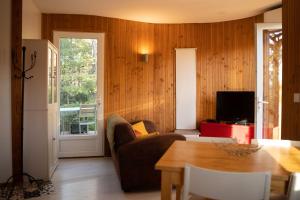a living room with a couch and a table at Chalet dans plusieurs hectares de nature in Barjols