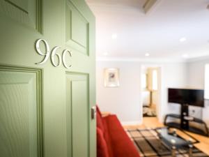 a living room with a green door and a couch at Vauxhall Apartments in Norwich