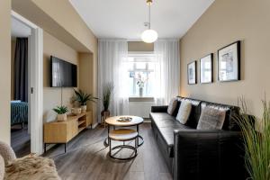 a living room with a couch and a table at Baldur Apartments in Reykjavík