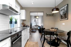 a kitchen with a table and a dining room at Baldur Apartments in Reykjavík