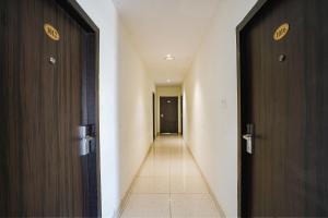 a hallway with two wooden doors and a hallway with at FabHotel Prime D Dev in Vijayawāda