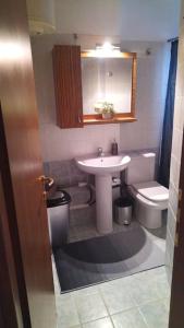 a bathroom with a sink and a toilet at Shiny house near to sea @patra in Patra