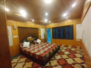 a woman laying on a bed in a room at Sheraz Guest House , Tangmarg in Tangmarg