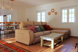 a living room with a couch and a table at Canto do Vale in Aljezur