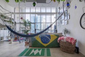 a hammock hanging in a room with a couch at City Haven 1br Loft Remote Work, Projector Tv in Dubai