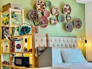 a bedroom with plates on the wall and a bed at Rustic Elegance By The Lake Studio Cabin In Jlt in Dubai +37 photos