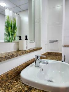 a bathroom with a sink and a mirror at Rustic Elegance By The Lake Studio Cabin In Jlt in Dubai