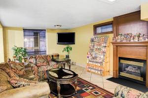 sala de estar con sofás y chimenea en Days Inn & Suites by Wyndham Downtown Gatlinburg Parkway, en Gatlinburg