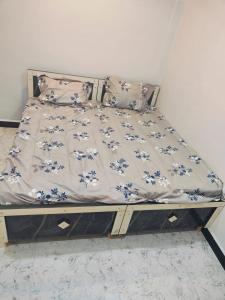 uma cama com uma colcha floral em VARDAN PALACE em Ujaim