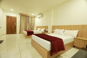 a hotel room with two beds in a room at Slice of Heaven in Mundakāyam
