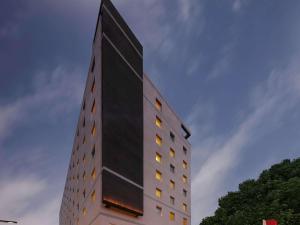 a tall black building with windows on the side of it at ibis Coimbatore City Centre - An Accor Brand in Coimbatore