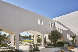 an external view of a building with arches at Atlantica Beach Resort Kos in Kardamaina
