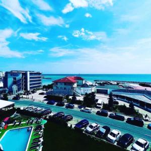 a parking lot with cars parked next to the ocean at Hotel Venus in Venus +16 photos