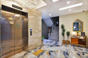 a lobby with a elevator and a staircase at Hotel Palace Gyeongju in Gyeongju