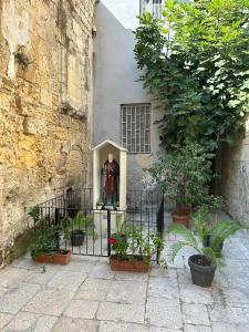 Eine Statue eines Mannes, der neben einem Gebäude steht. in der Unterkunft Al rifugio di rosmy in Bari + 2 Fotos