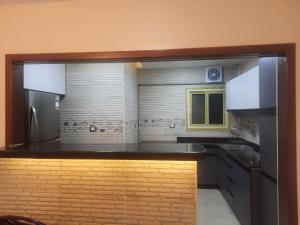 a kitchen with a counter top and a refrigerator at Bright CityStars in Cairo