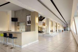 a lobby with a bar in a building at The Haas, Trademark Collection by Wyndham in Los Angeles