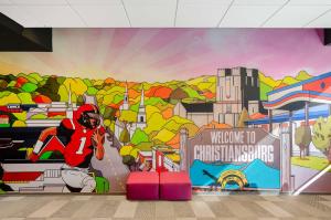 a mural of a football player on a wall at Tru By Hilton Christiansburg in Christiansburg