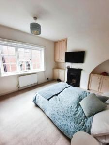a bedroom with a large bed and a television at City Chester Entire House Central in Chester