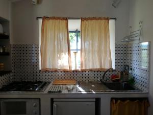 a kitchen with a sink and a window at Agriturismo Selvoli - La Civetta in Pienza