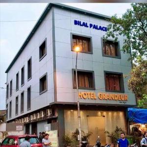 a hotel building with a light in front of it at Grandeur By Avion Palace Near T2 International Airport in Mumbai