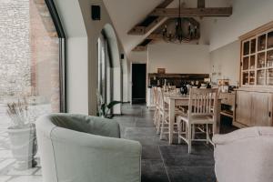 a dining room with a table and chairs at Les Arbres sous le vent à 10 min de Pairi Daiza in Jurbise
