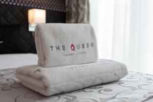 a pile of towels sitting on top of a bed at VILLA ADRIANA-The Queen Apartments Luxury Living in Luxembourg