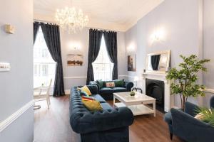 a living room with a couch and a fireplace at 4 Poster Luxury Georgian Apartment in Dublin